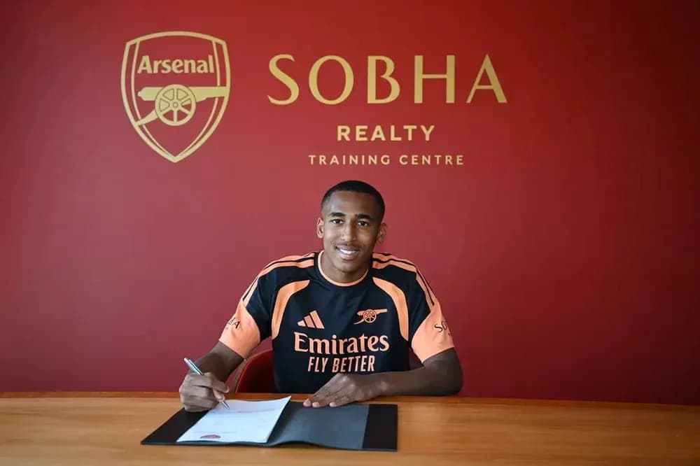 Yeni transfer müqaviləsi imzalayan oyunçu masada oturur