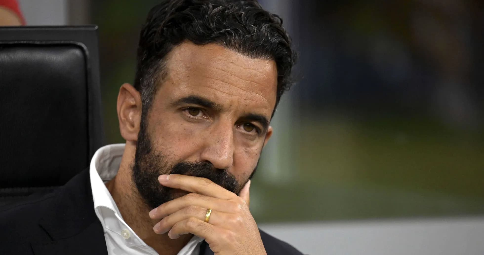 Football manager deep in thought during match