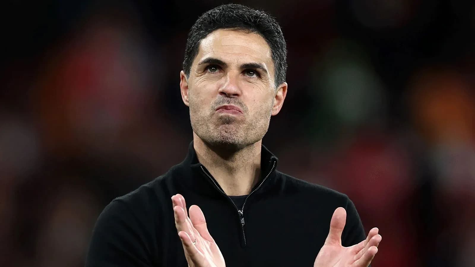 Coach applauding during match at stadium