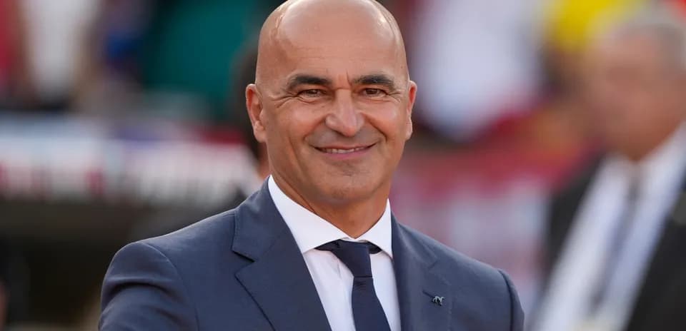A man in a suit smiling at an event