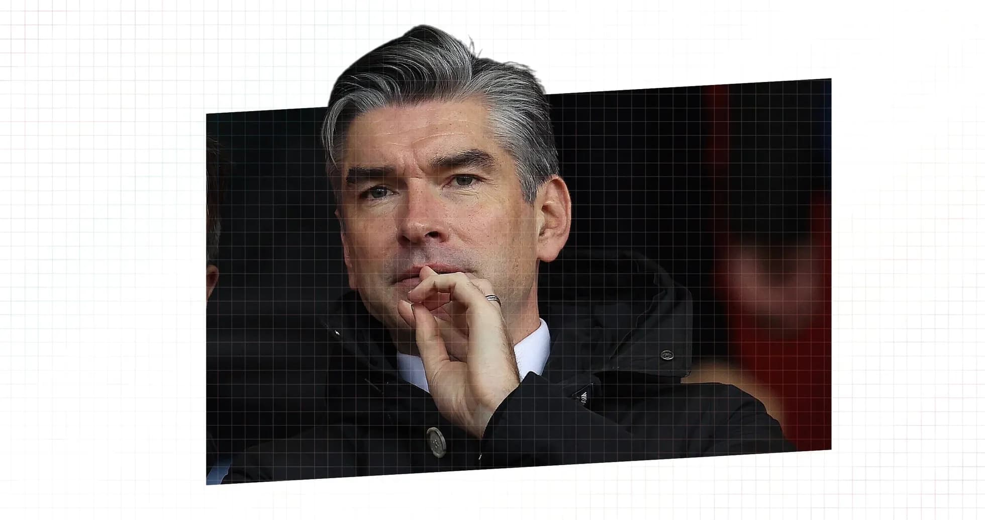Men's football manager observing the match thoughtfully