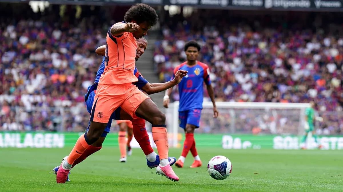 Barcelona player tackling opponent during match action Barcelona player tackling opponent during match action
