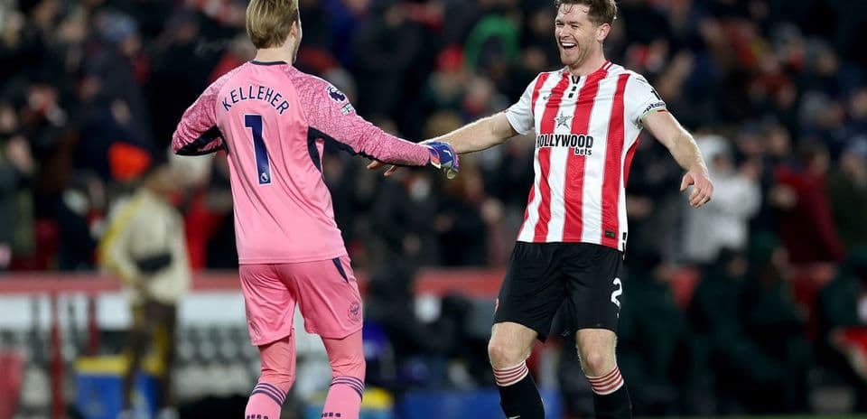 Goalkeeper and defender celebrating after match
