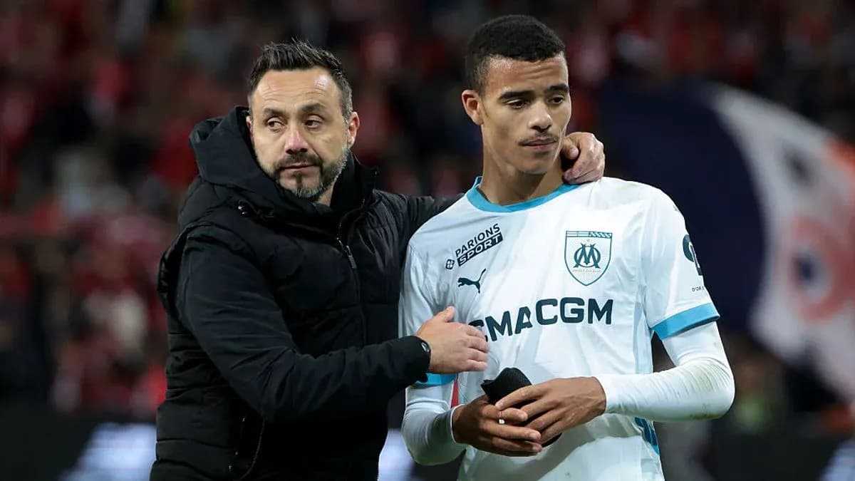An assistant coach comforting a player after match