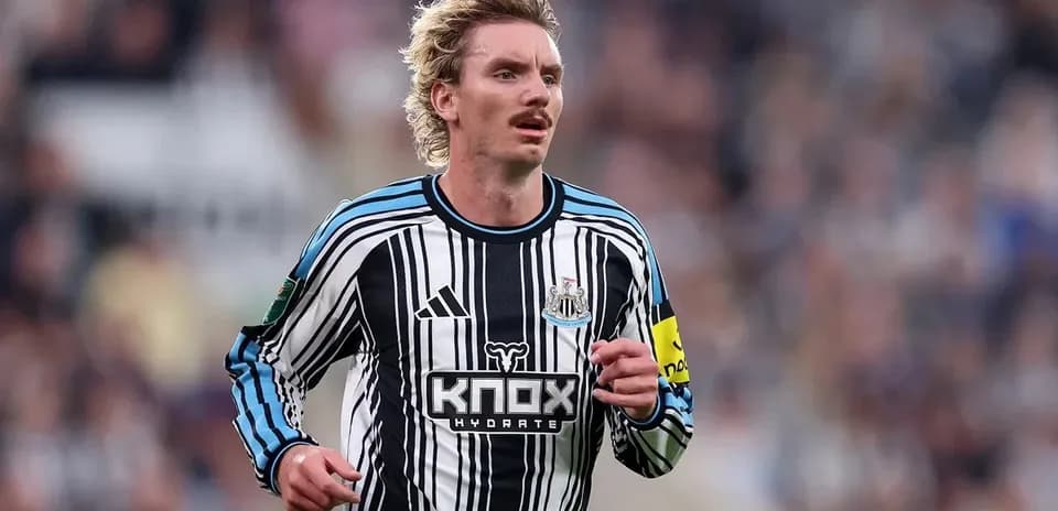 Newcastle player running on the pitch during match