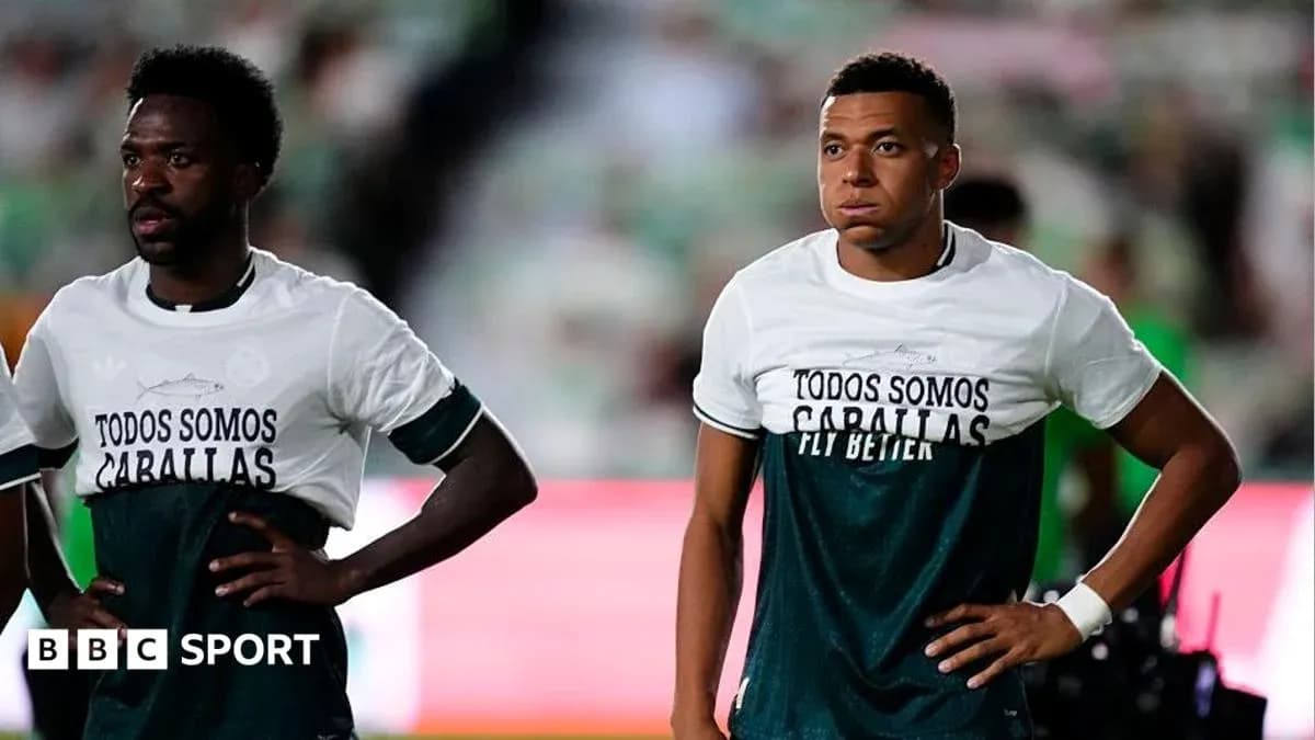Two players wearing warm-up shirts on the field