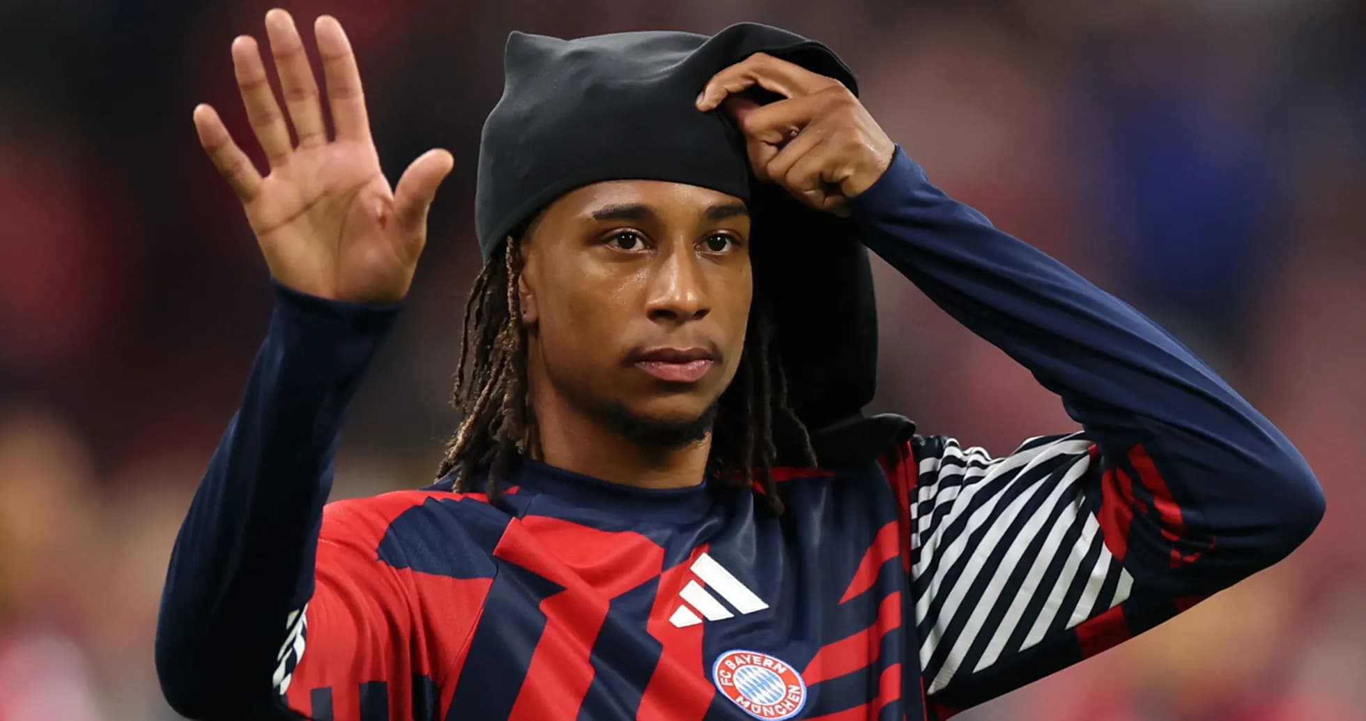 Bayern Munich player waving while adjusting headwear