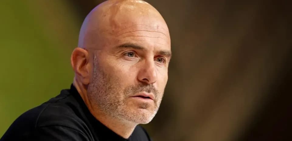 Men's football manager speaking at press conference