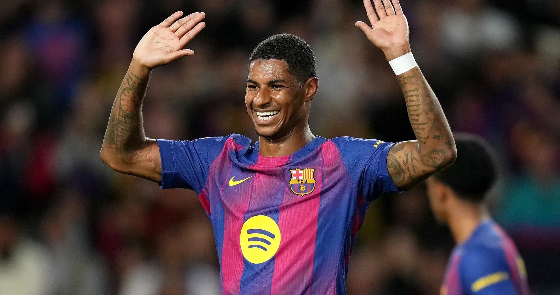 Barcelona player celebrating with raised hands