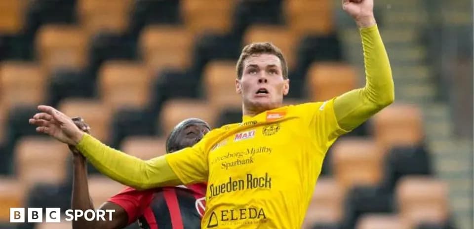 Player in yellow shirt competing for the ball