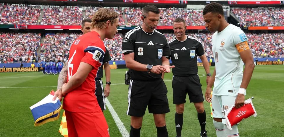 Captains and referees during coin toss before match