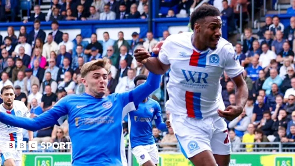 Player in blue attempting to tackle player in white