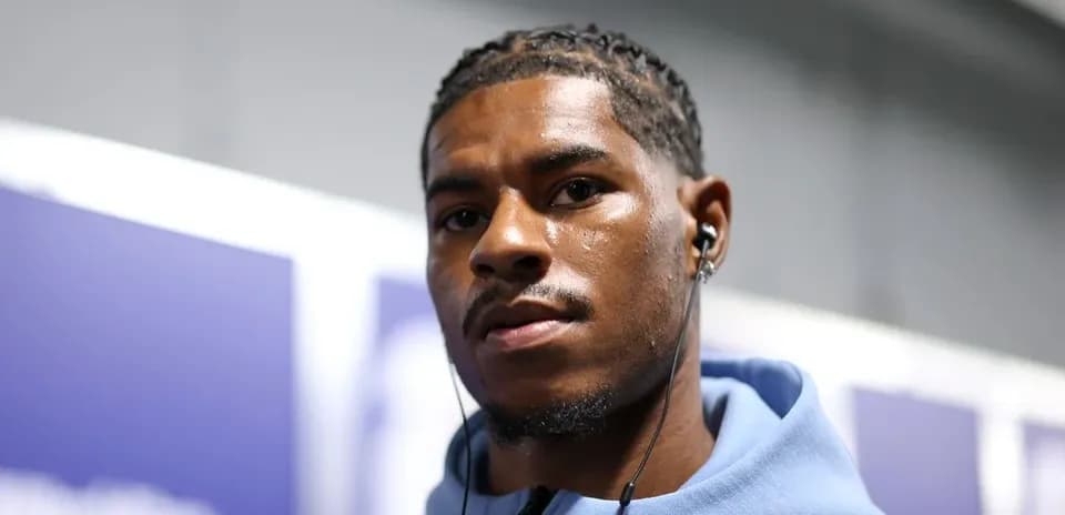 Athlete wearing headphones in hallway before event