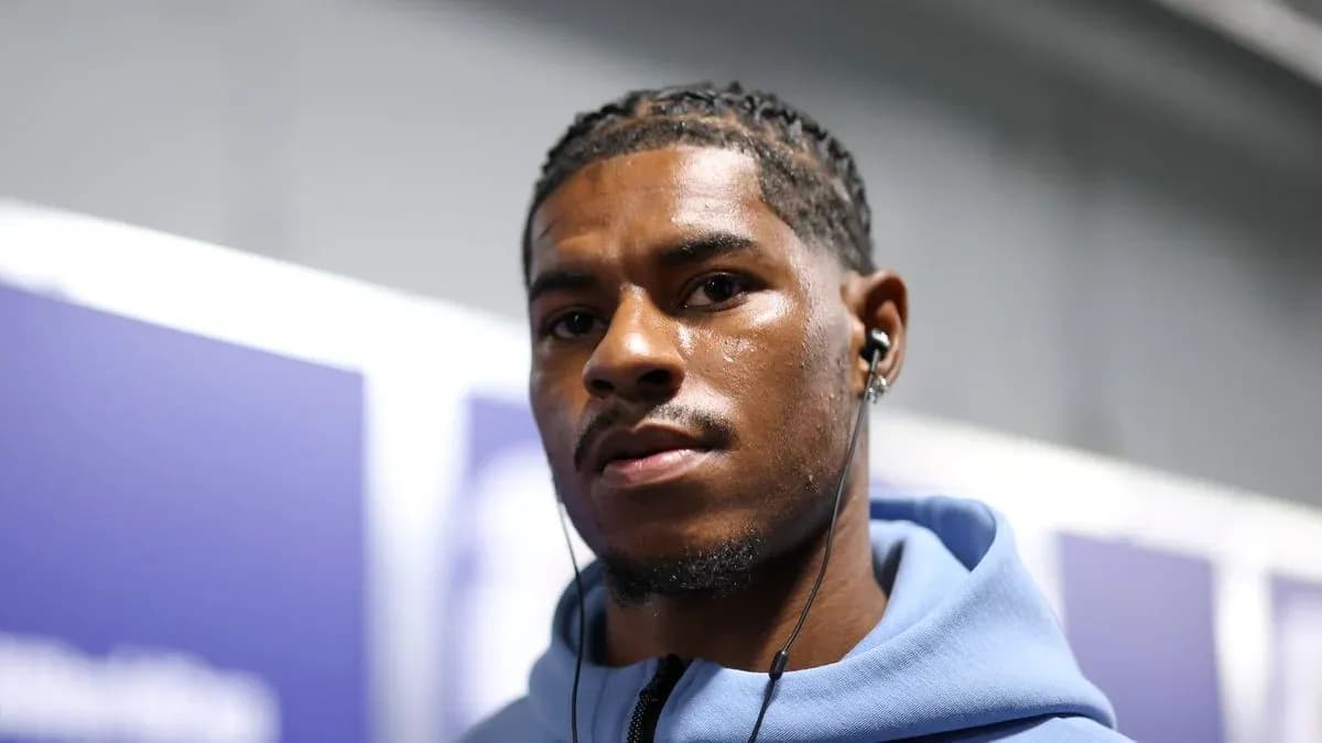 Athlete wearing headphones in hallway before event