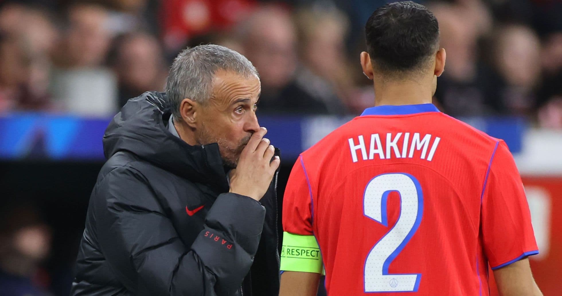 Coach giving instructions to player Hakimi on field