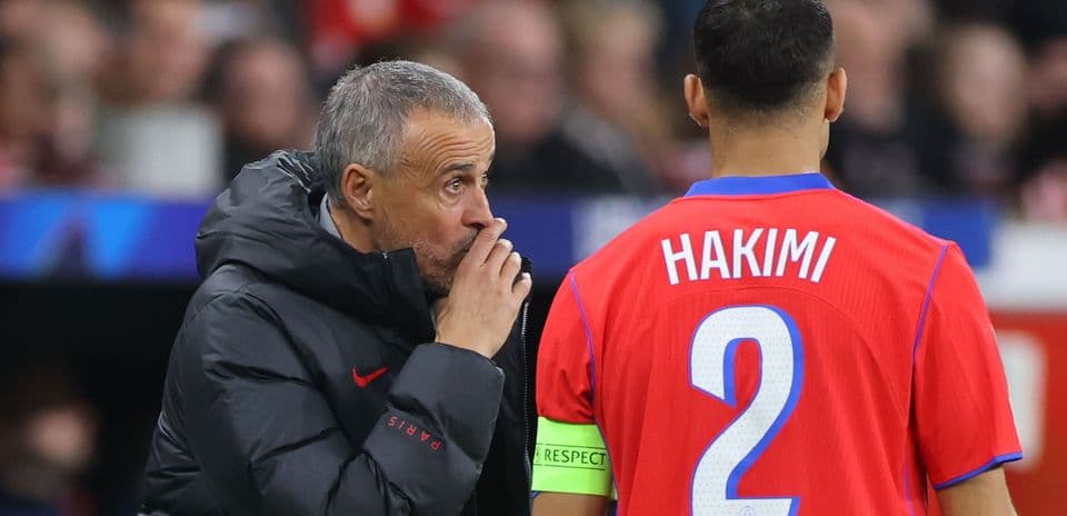 Coach giving instructions to player Hakimi on field