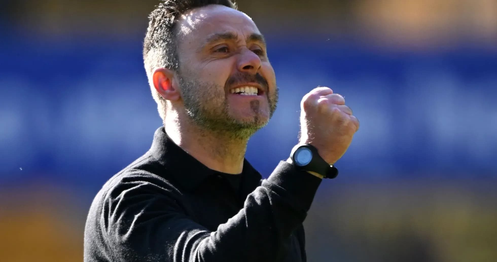 Coach celebrating with a clenched fist during match