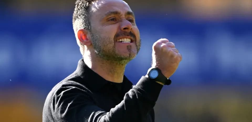 Coach celebrating with a clenched fist during match