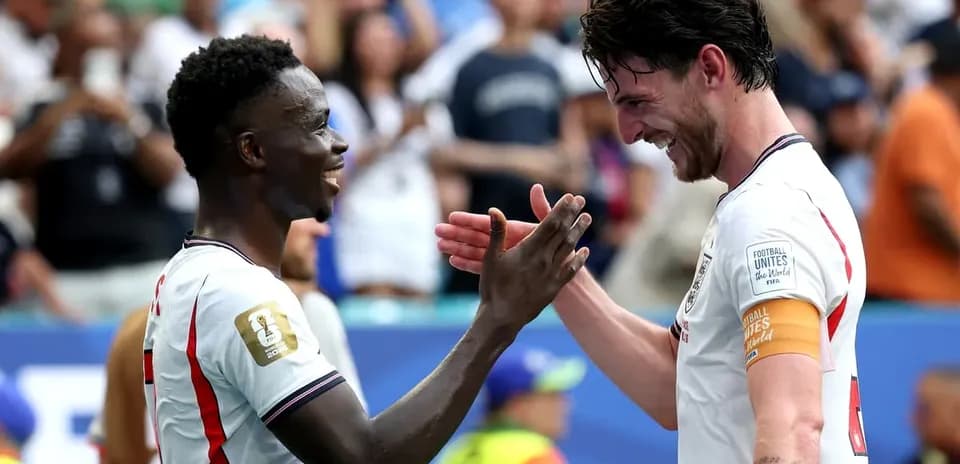 Two players celebrating on the pitch after match