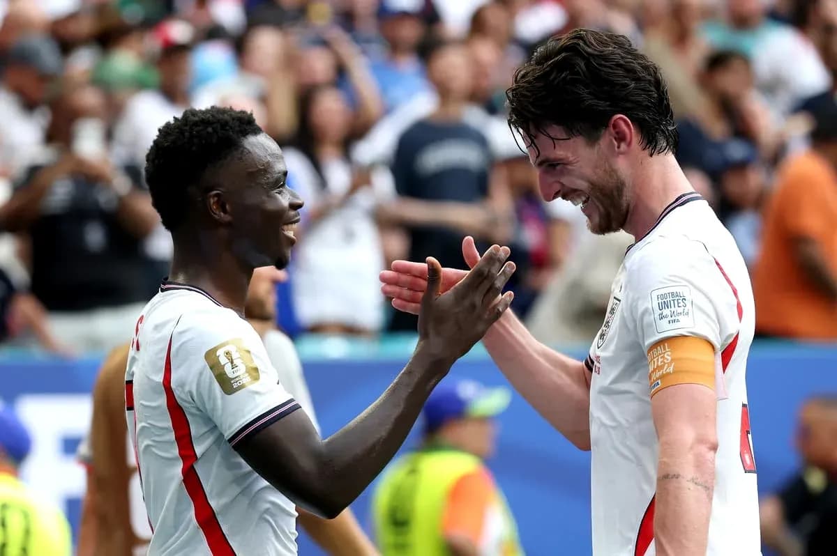 Two players celebrating on the pitch after match