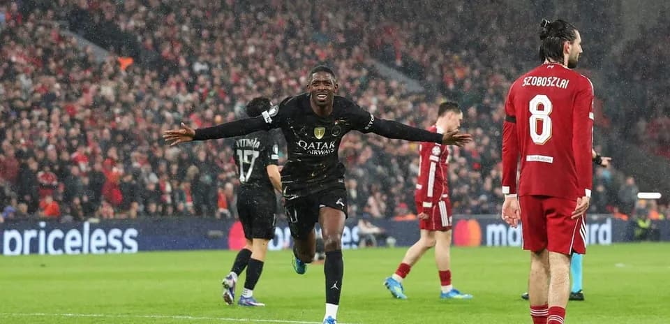 Player celebrating a goal in rainy match
