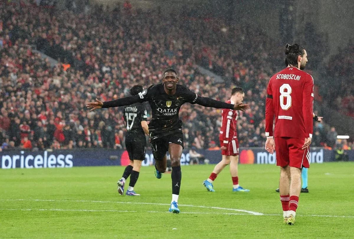 Player celebrating a goal in rainy match