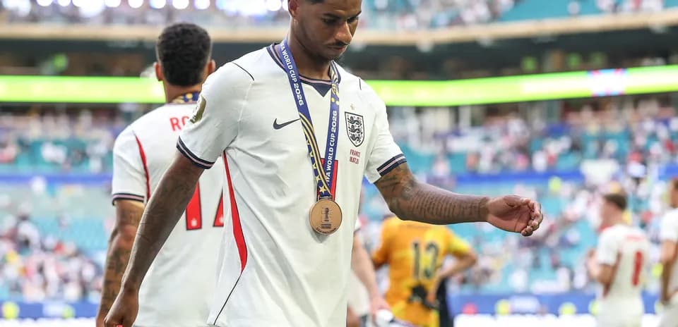 Player walking off field wearing medal after match
