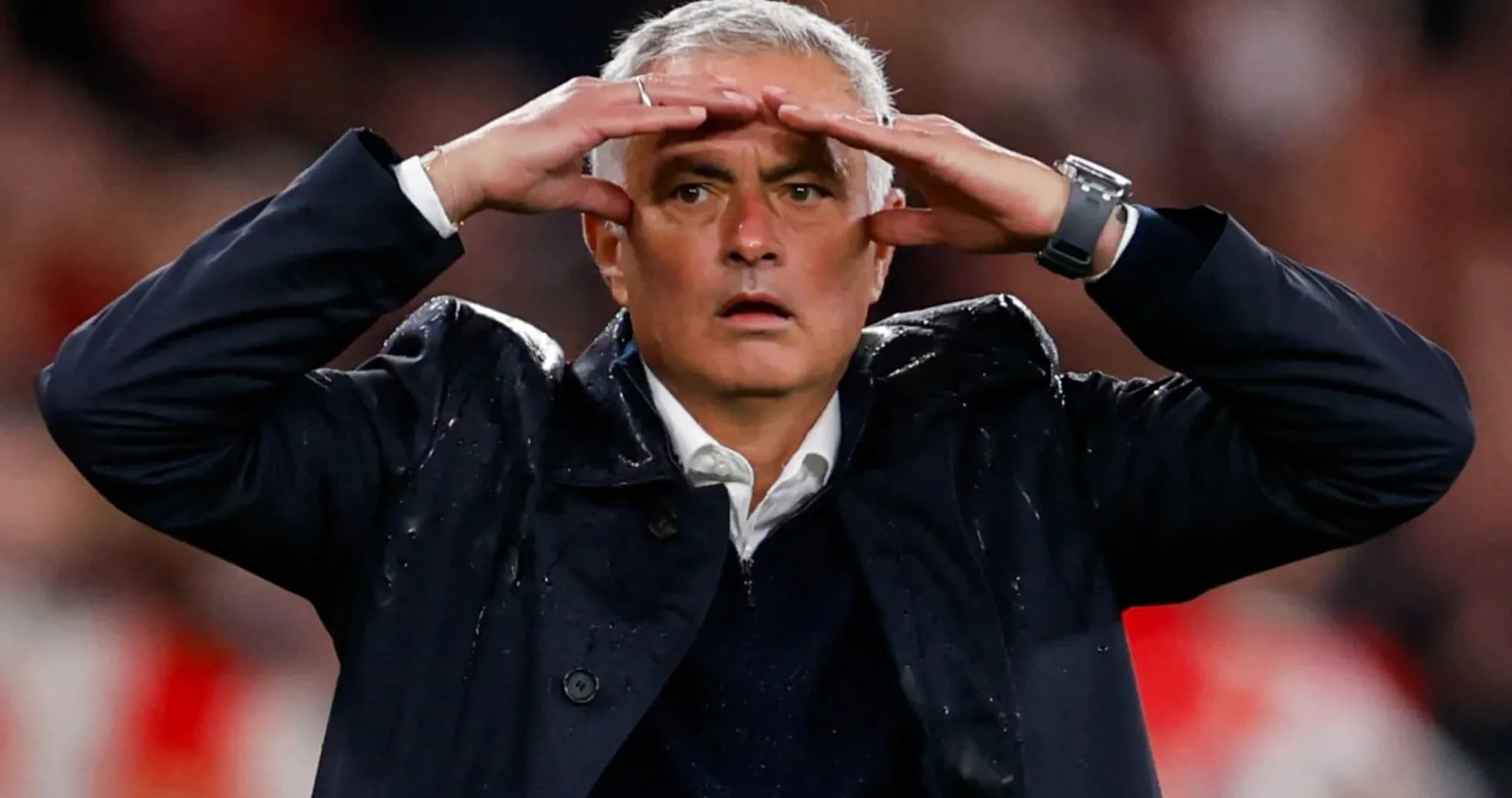 Football manager gesturing during a match