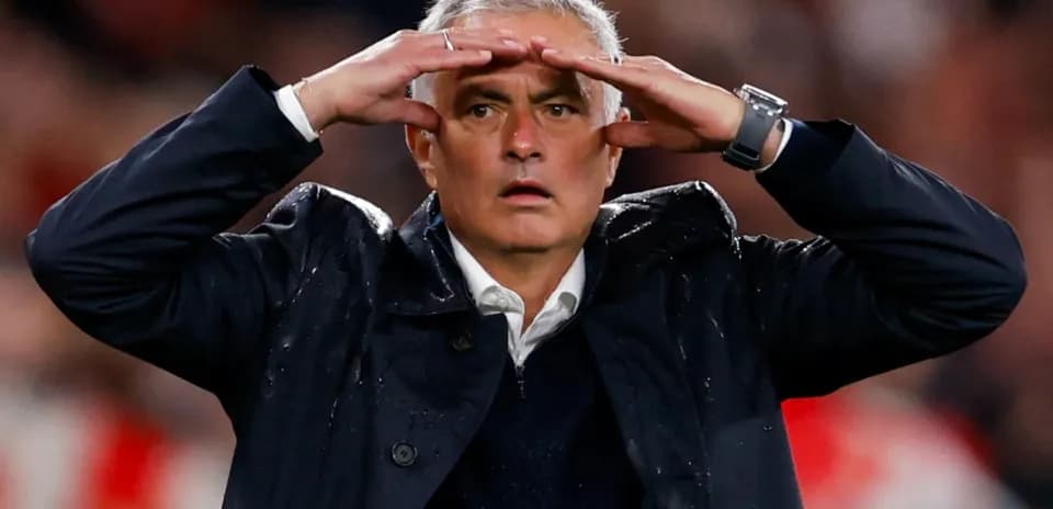 Football manager gesturing during a match