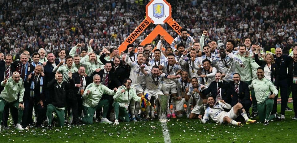 Aston Villa players celebrating trophy win on field