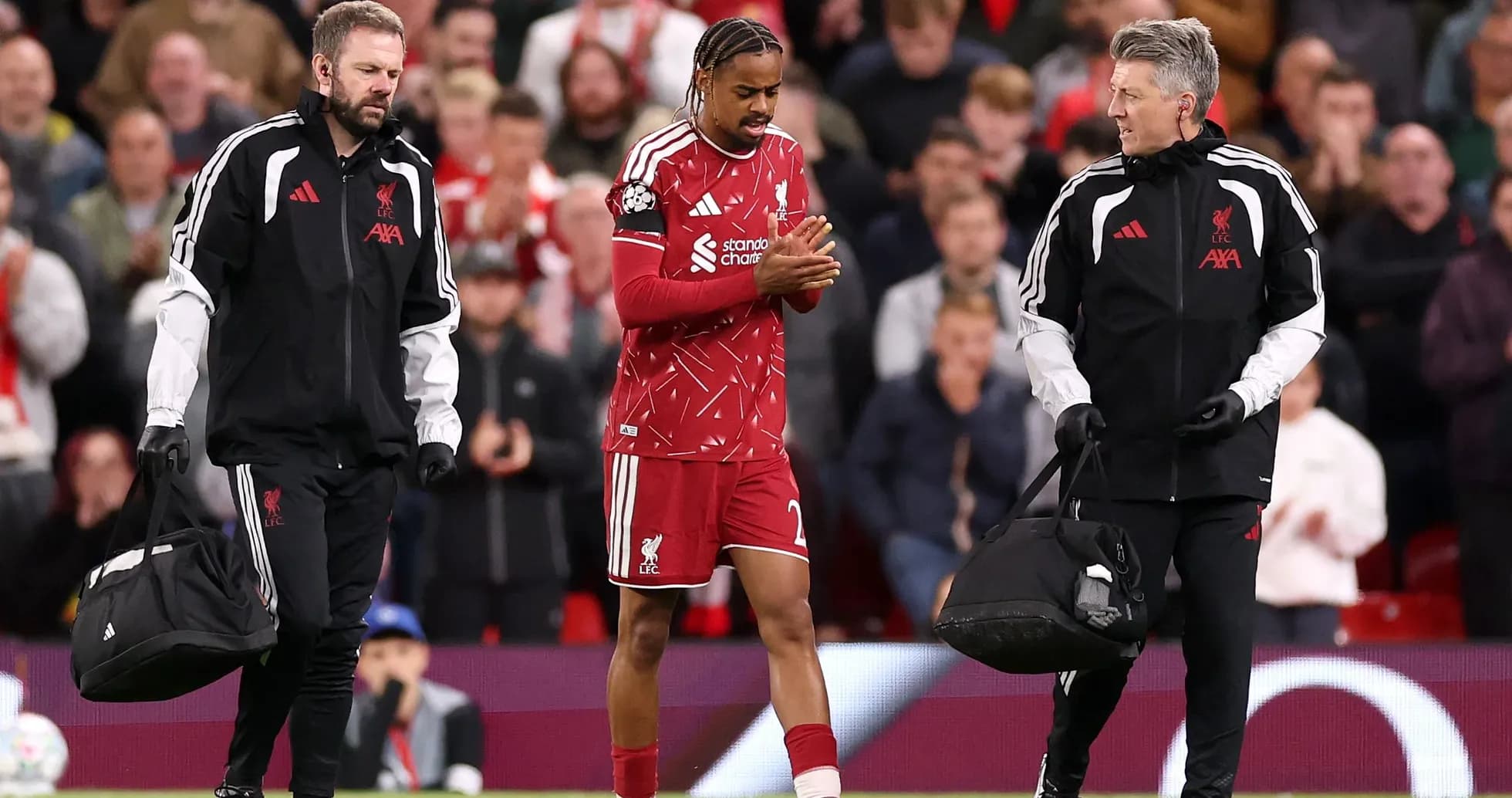 Liverpool player receiving medical attention on pitch