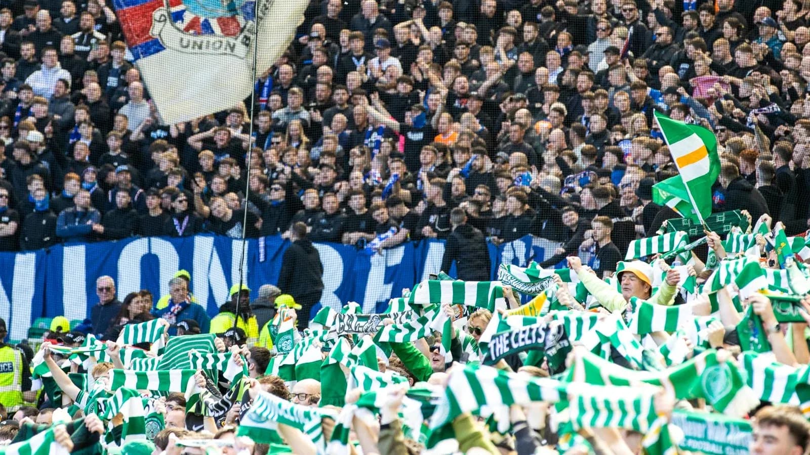 Fans waving scarves during football match celebration