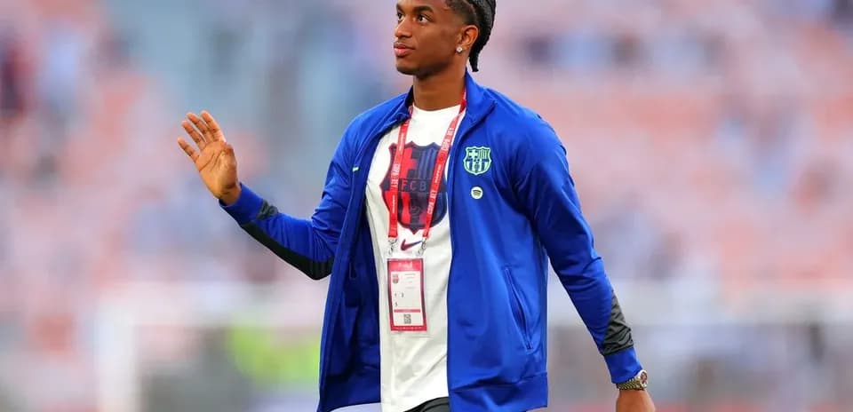 Player in FC Barcelona attire greeting fans