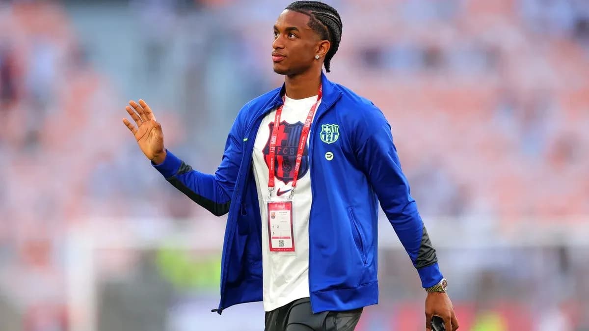 Player in FC Barcelona attire greeting fans
