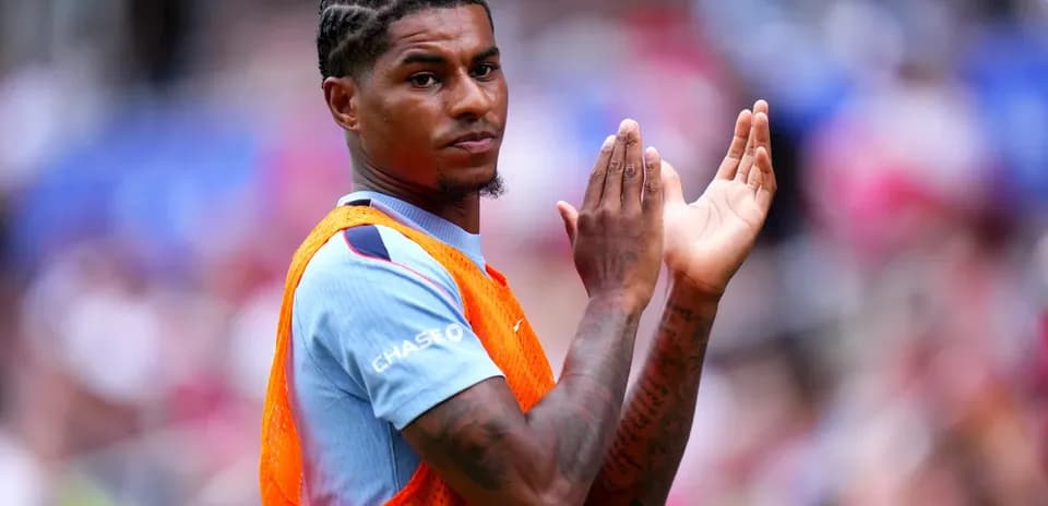 Player applauding during warm-up on the pitch