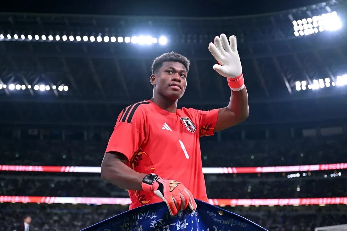 Goalkeeper waving while holding a banner