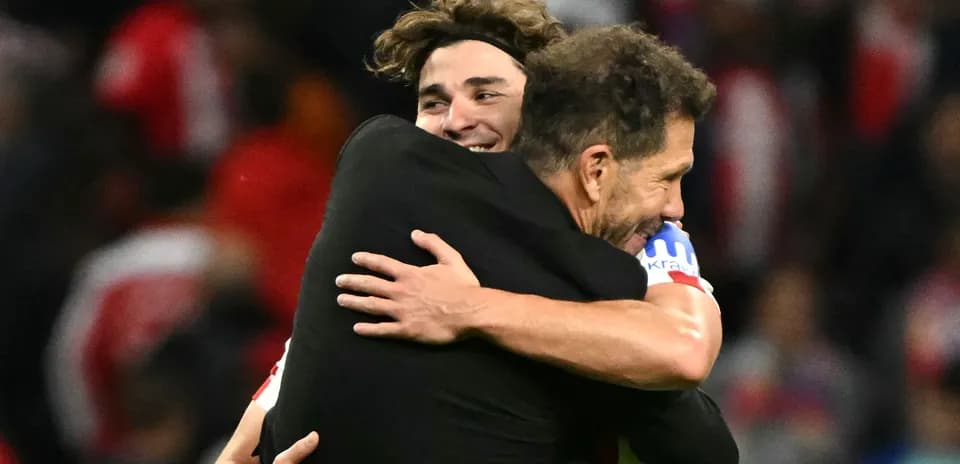 Player and coach embracing after a match victory
