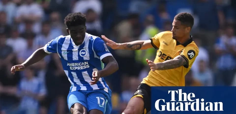 Player in blue shirt dribbling past opponent in yellow