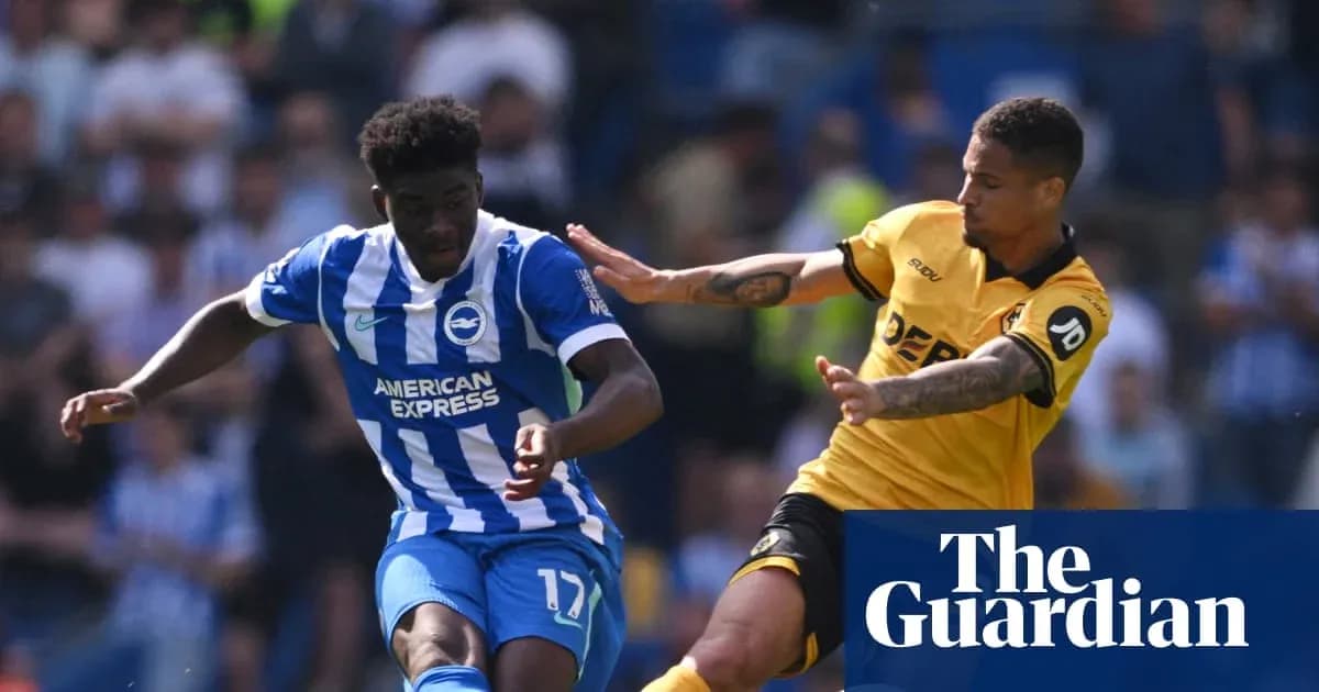 Player in blue shirt dribbling past opponent in yellow