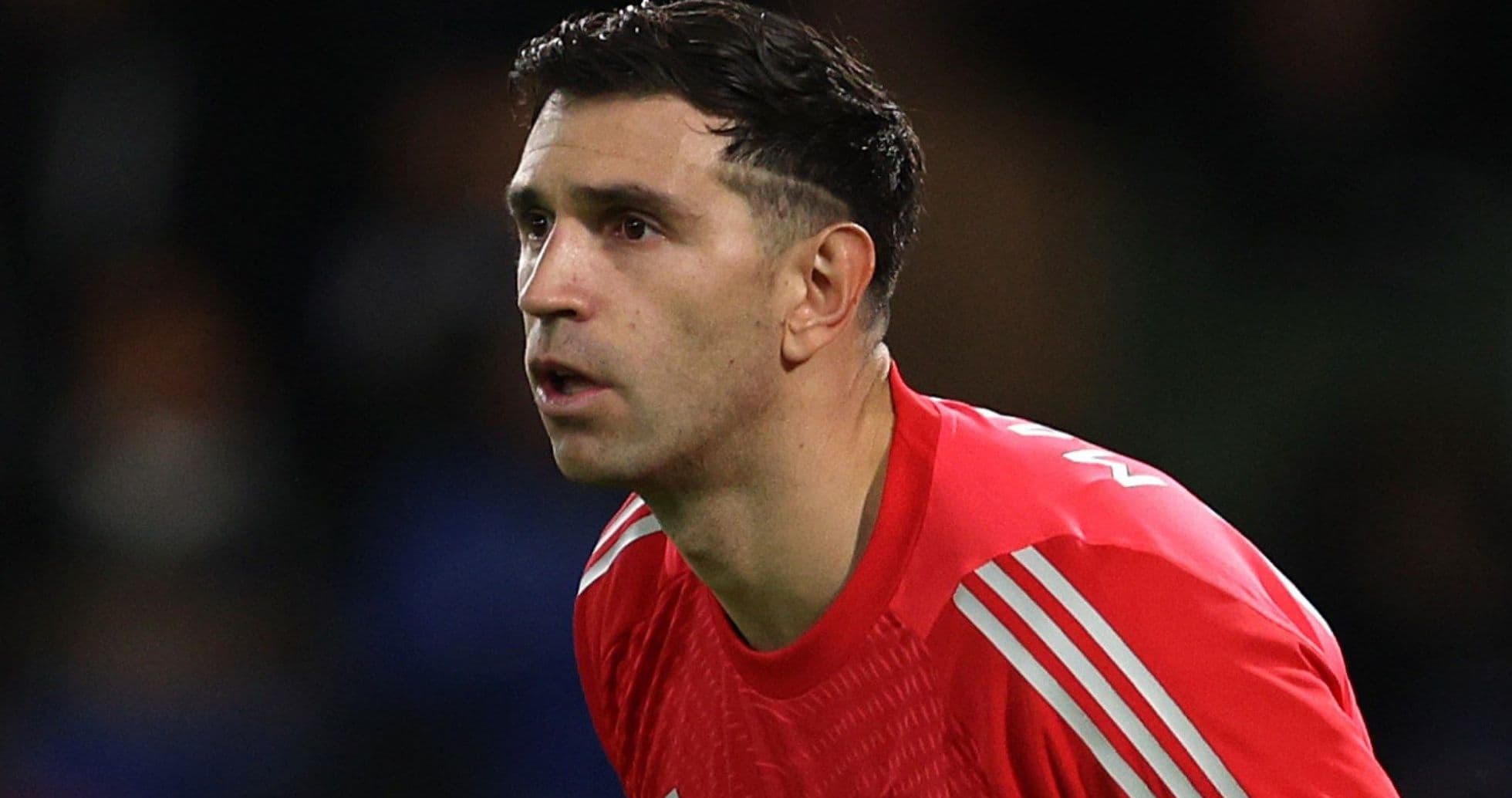Goalkeeper in red jersey preparing for play
