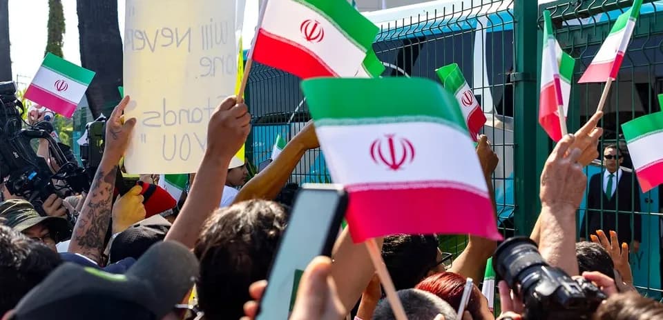 Crowd waving Iranian flags during protest event
