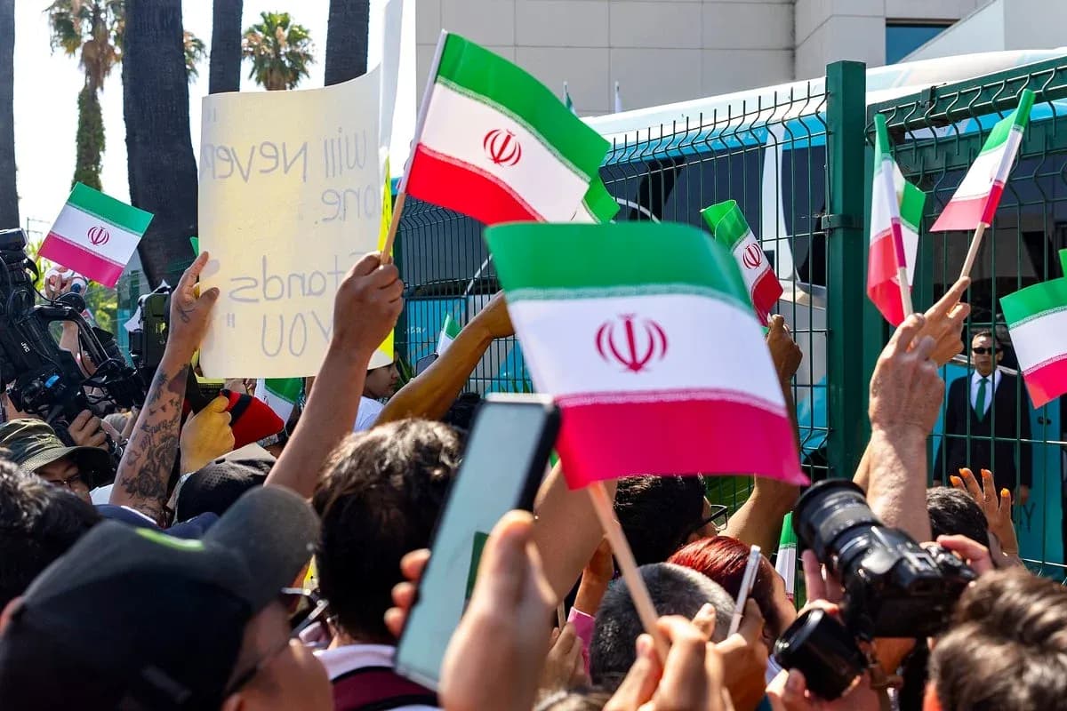 Crowd waving Iranian flags during protest event