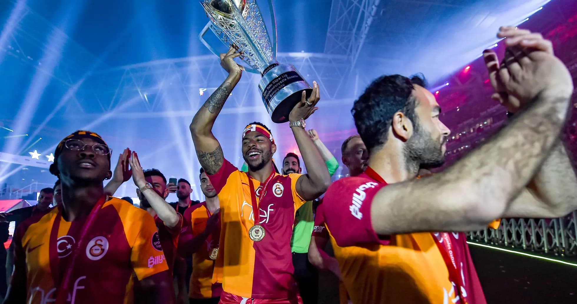 Galatasaray player celebrating with trophy after victory