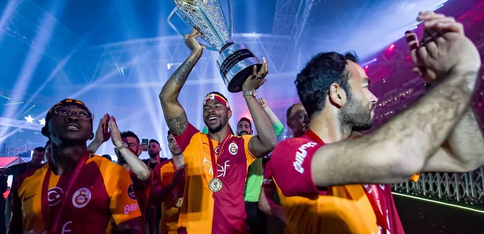 Galatasaray player celebrating with trophy after victory