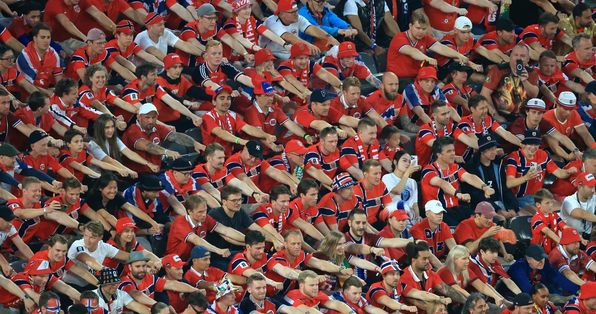 Large crowd of fans in red jerseys at event