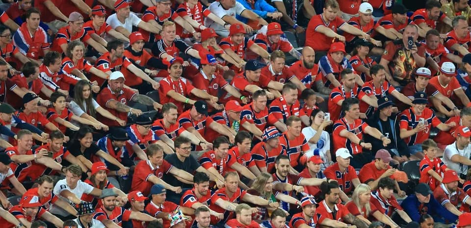 Large crowd of fans in red jerseys at event