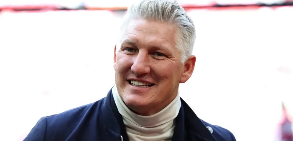 Former player smiling at stadium entrance
