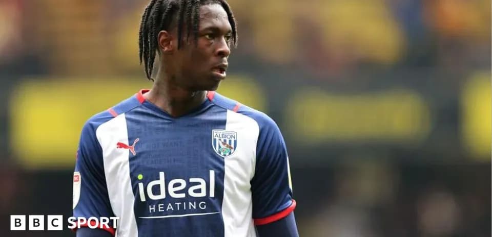 Football player in West Bromwich Albion jersey on field