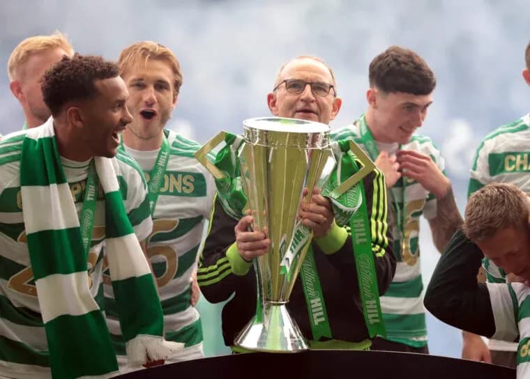 Celtic players celebrating with trophy after victory