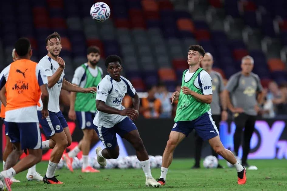 Players training and practicing ball control on pitch